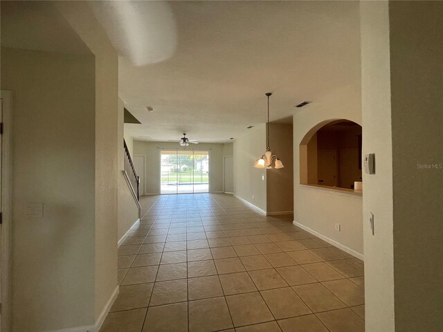 tiled empty room with ceiling fan