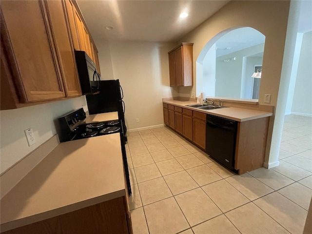 kitchen with sink, light tile patterned floors, and black appliances