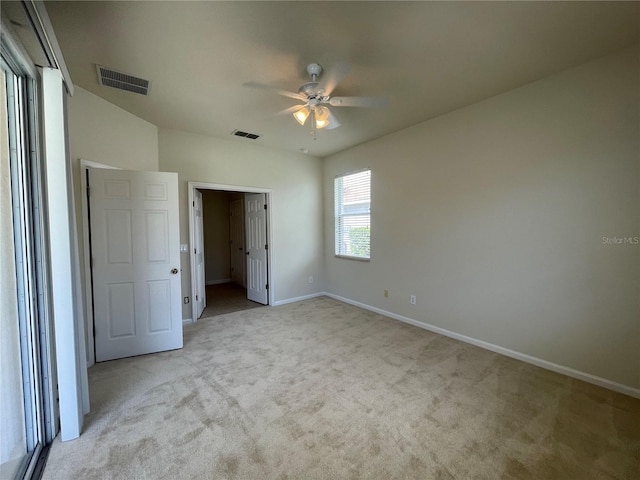 unfurnished bedroom with ceiling fan and light carpet