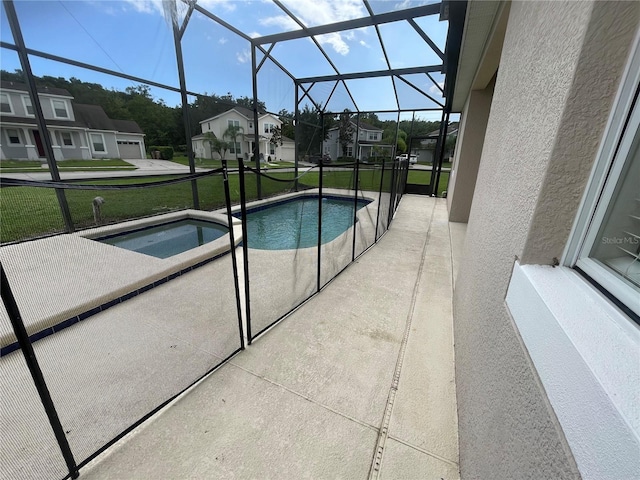 view of pool featuring a lawn, glass enclosure, and a patio area