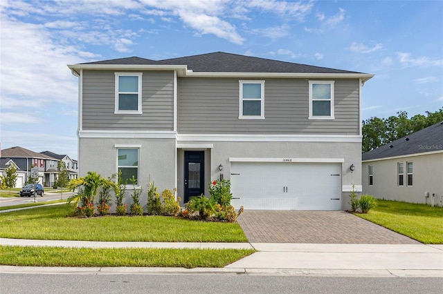 front of property with a front yard and a garage