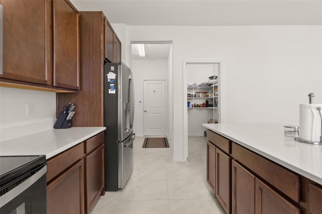 kitchen featuring light tile patterned floors and stainless steel fridge with ice dispenser