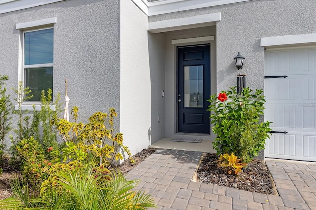 doorway to property with a garage