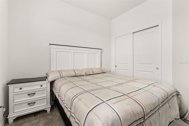 bedroom with dark colored carpet and a closet