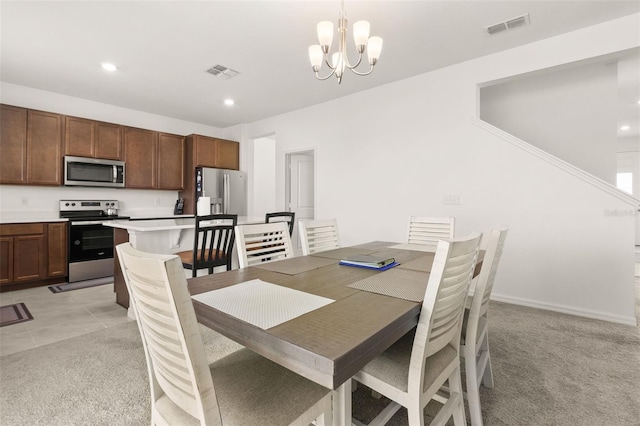 carpeted dining room featuring an inviting chandelier