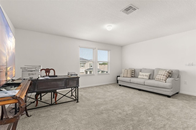 carpeted office featuring a textured ceiling