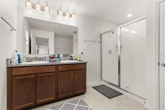 bathroom with tile patterned floors, an enclosed shower, and vanity