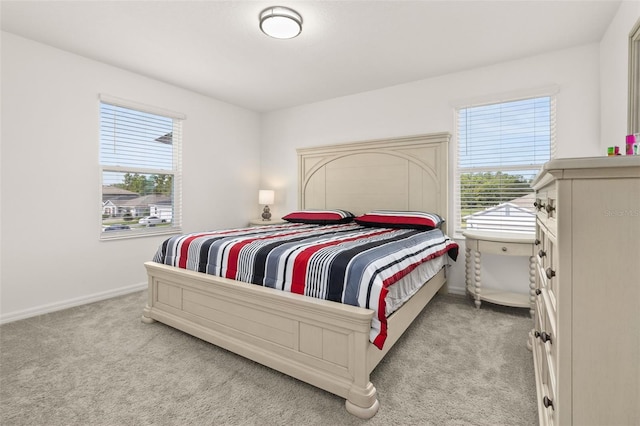 carpeted bedroom featuring multiple windows