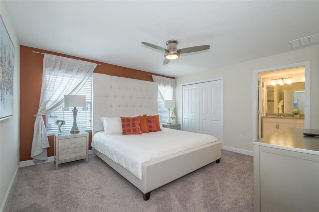 bedroom featuring ceiling fan, light carpet, and multiple windows