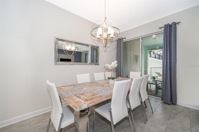 dining area featuring light tile patterned flooring and a chandelier