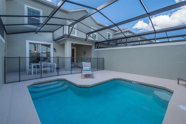 view of swimming pool with a lanai and a patio area