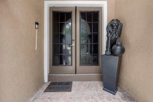 view of exterior entry featuring french doors