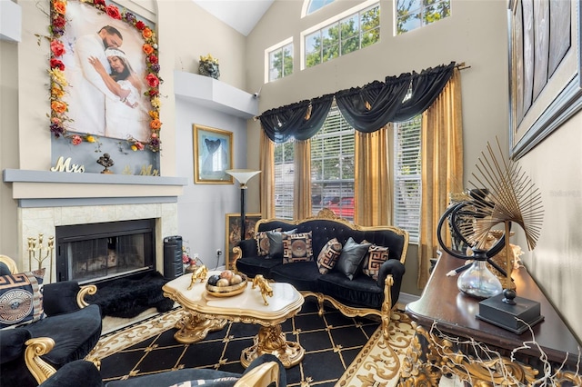 living room featuring high vaulted ceiling, a tile fireplace, tile patterned floors, and a healthy amount of sunlight