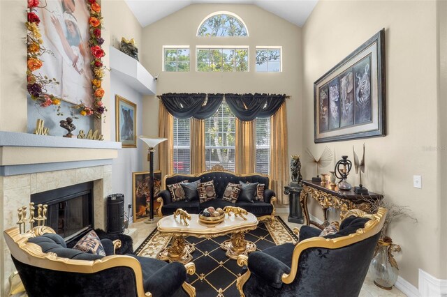 tiled living room with high vaulted ceiling and a fireplace