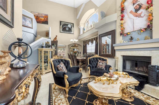 interior space with a tiled fireplace, a high ceiling, and light tile patterned floors