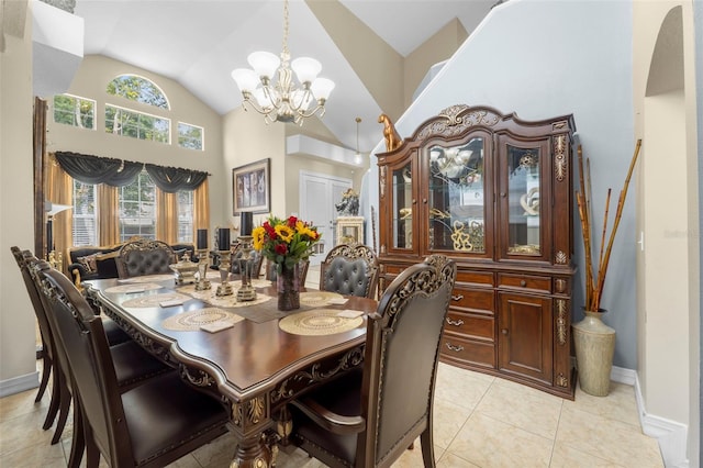 dining area featuring high vaulted ceiling, an inviting chandelier, and light tile patterned flooring