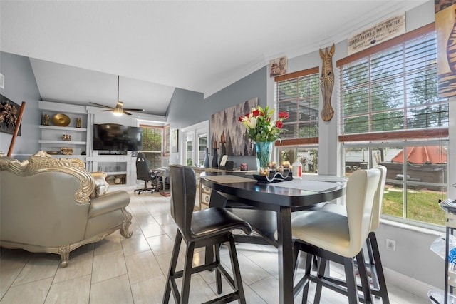 tiled dining room featuring ceiling fan and vaulted ceiling