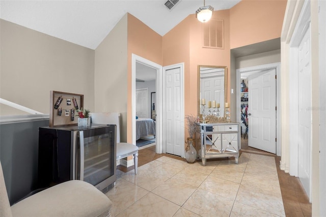 bathroom with tile patterned flooring and high vaulted ceiling