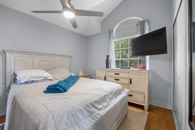 bedroom featuring ceiling fan, a closet, vaulted ceiling, and light tile patterned flooring