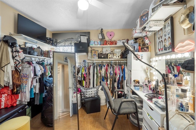 spacious closet with ceiling fan and tile patterned floors