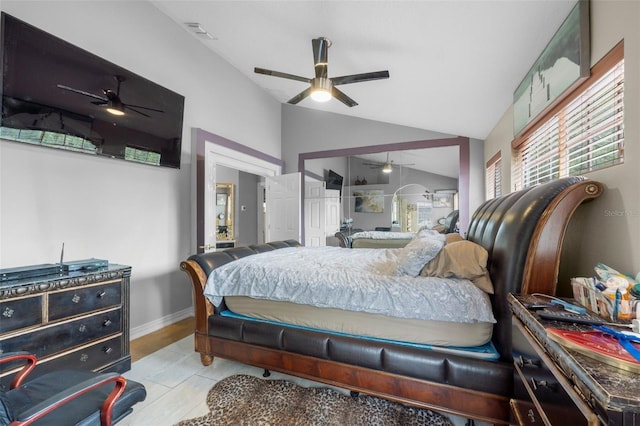 tiled bedroom with ceiling fan, a closet, and vaulted ceiling