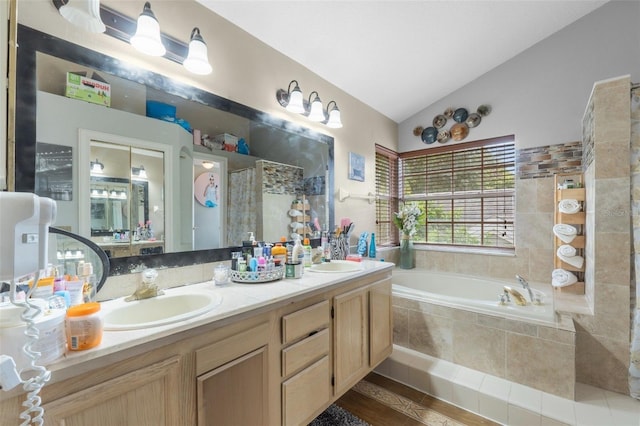 bathroom featuring vaulted ceiling, plus walk in shower, vanity, and wood-type flooring