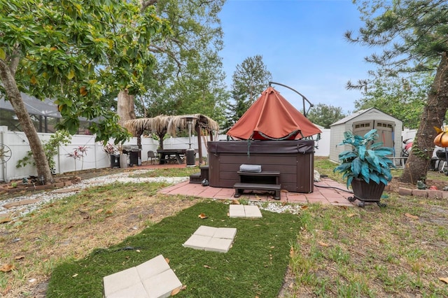 view of yard with a hot tub and a storage unit