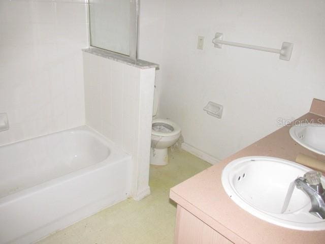 bathroom featuring toilet and vanity