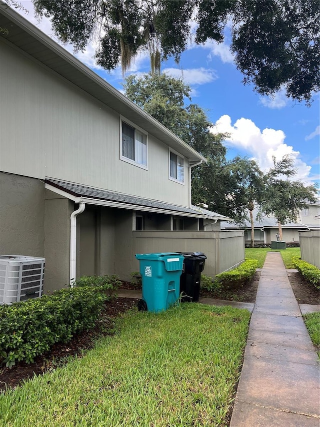 view of home's exterior with a yard and central AC unit