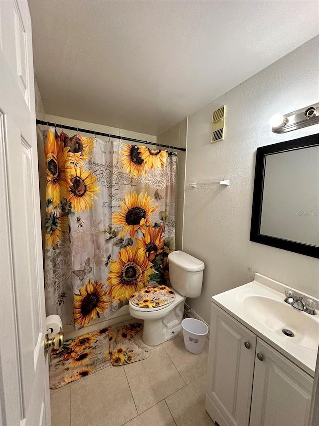 bathroom featuring a shower with shower curtain, vanity, toilet, and tile patterned floors