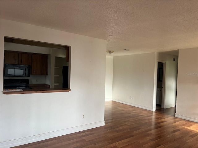 interior space featuring a textured ceiling and dark hardwood / wood-style flooring