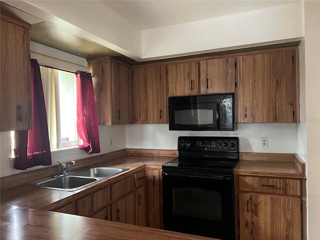 kitchen featuring black appliances, butcher block countertops, and sink