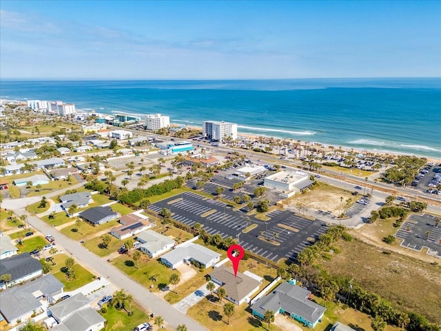 drone / aerial view featuring a water view and a beach view