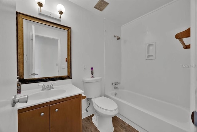 bathroom with shower / washtub combination, vanity, toilet, and wood finished floors