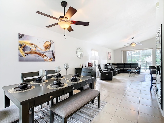 dining space featuring ceiling fan, vaulted ceiling, and light tile patterned flooring