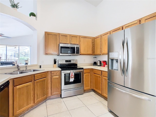 kitchen with sink, appliances with stainless steel finishes, and light tile patterned flooring