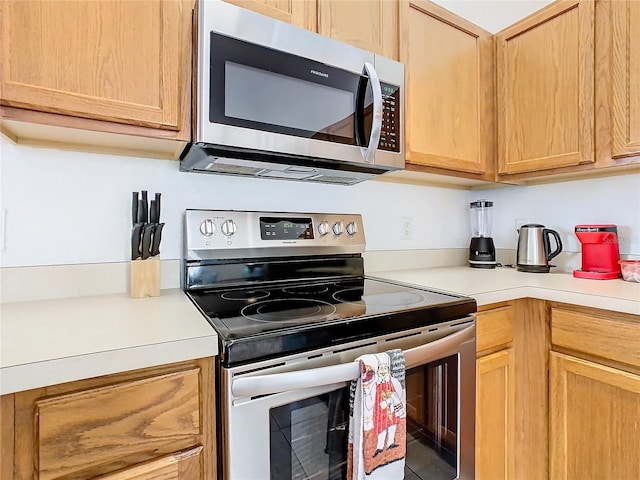 kitchen with light brown cabinets and stainless steel appliances