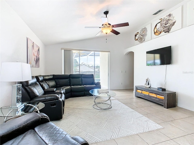 tiled living room featuring ceiling fan and vaulted ceiling