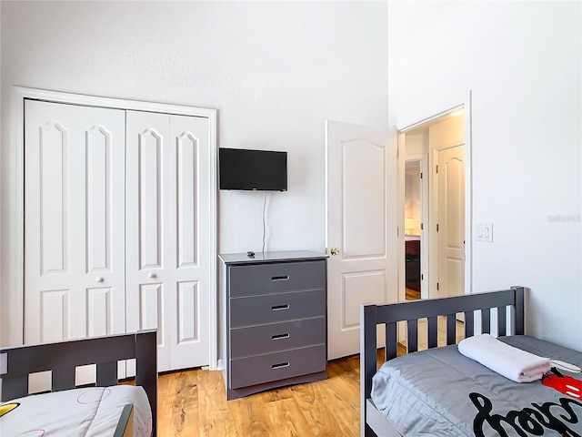 bedroom featuring light hardwood / wood-style flooring and a closet