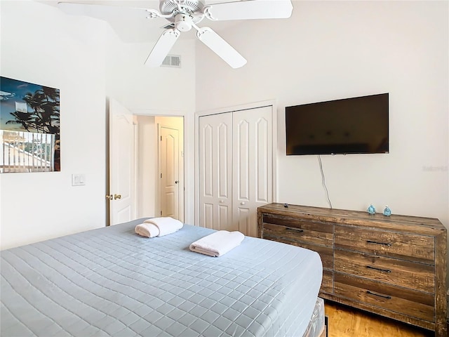 bedroom with hardwood / wood-style flooring, a closet, and ceiling fan