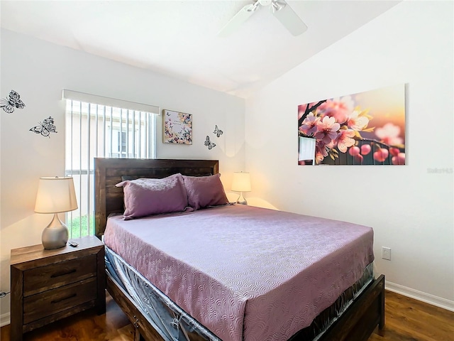 bedroom with ceiling fan, dark wood-type flooring, and lofted ceiling