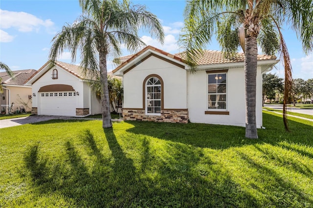 view of front of house featuring a garage and a front lawn