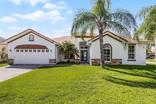 view of front of property featuring a garage and a front lawn