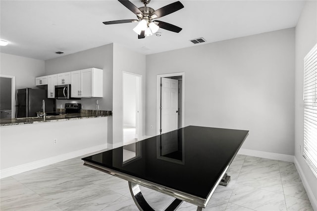 interior space featuring white cabinets, appliances with stainless steel finishes, ceiling fan, and a healthy amount of sunlight