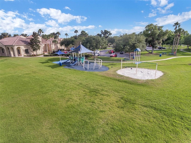 exterior space with a playground and a lawn