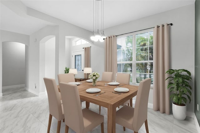 dining space featuring an inviting chandelier