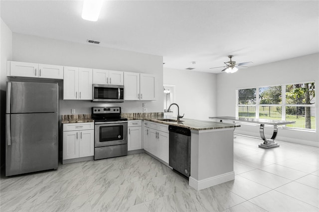 kitchen featuring kitchen peninsula, sink, stainless steel appliances, and white cabinets