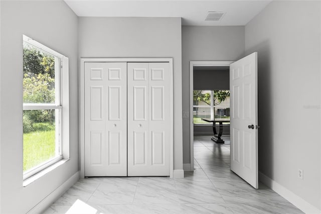 bedroom featuring multiple windows and a closet