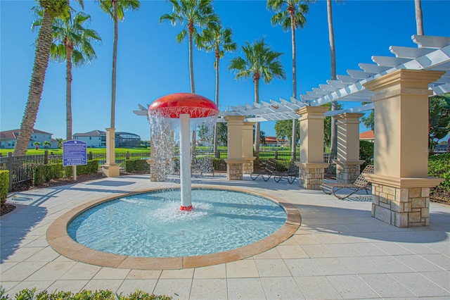 view of property's community featuring a pergola and a patio area