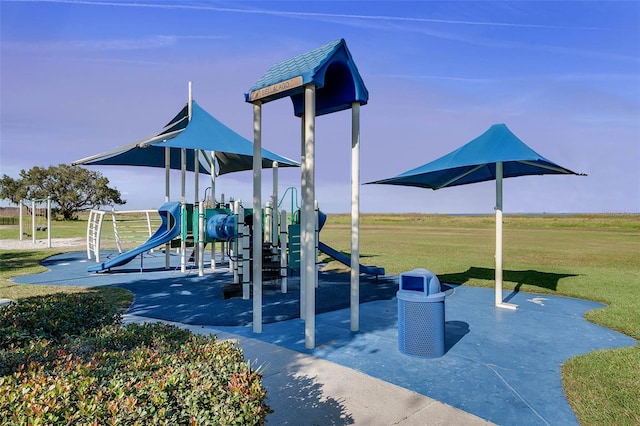 view of playground with a lawn